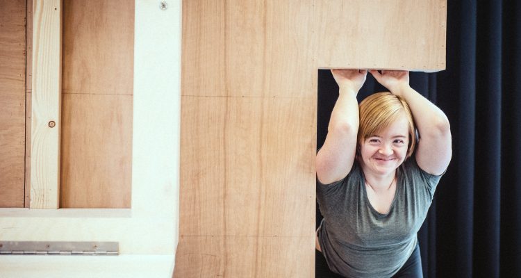 Portrait of Hannah Sampson, holding on to a piece of scenery from 'The Enormous Room'.
