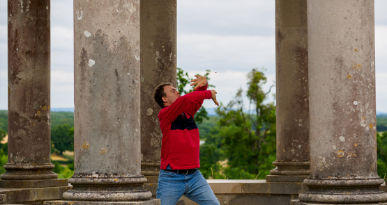 Chris dancing amongst old stone columns