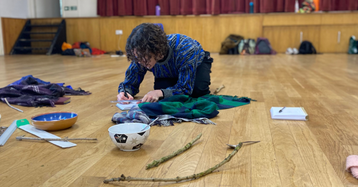 A dancer during a Home Practice research day, surrounded by idea generating objects 