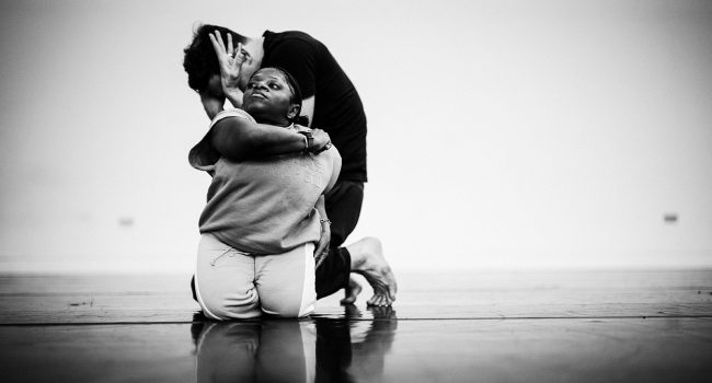 A black and white photo of dancers Mo and Christian during a duet.
