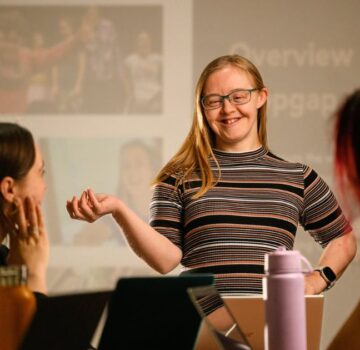 Hannah presenting in front of a screen