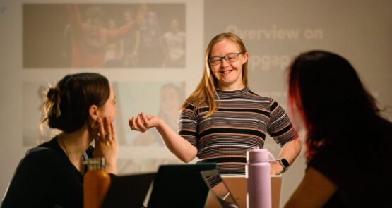Hannah presenting in front of a screen