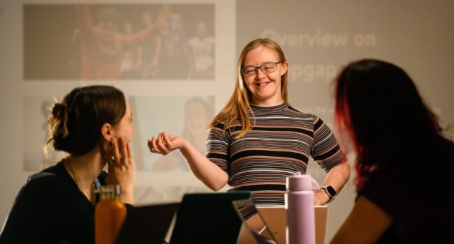 Hannah presenting in front of a screen