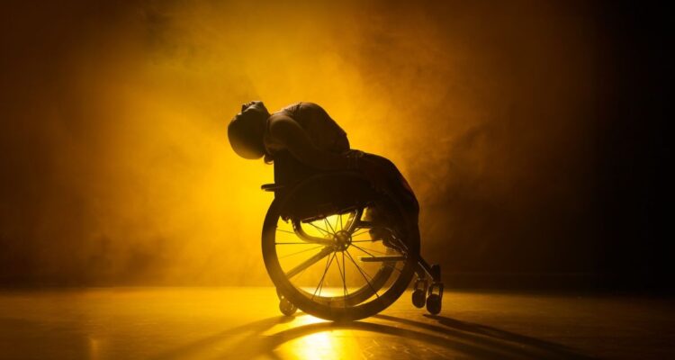 Backlit dancer in wheelchair