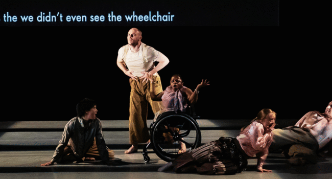 Five dancers on stage, a central wheelchair dancer looks shocked as a caption reads