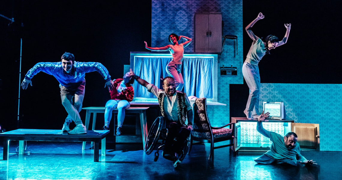 The full cast of The Enormous Room dance on the domestic living space set.