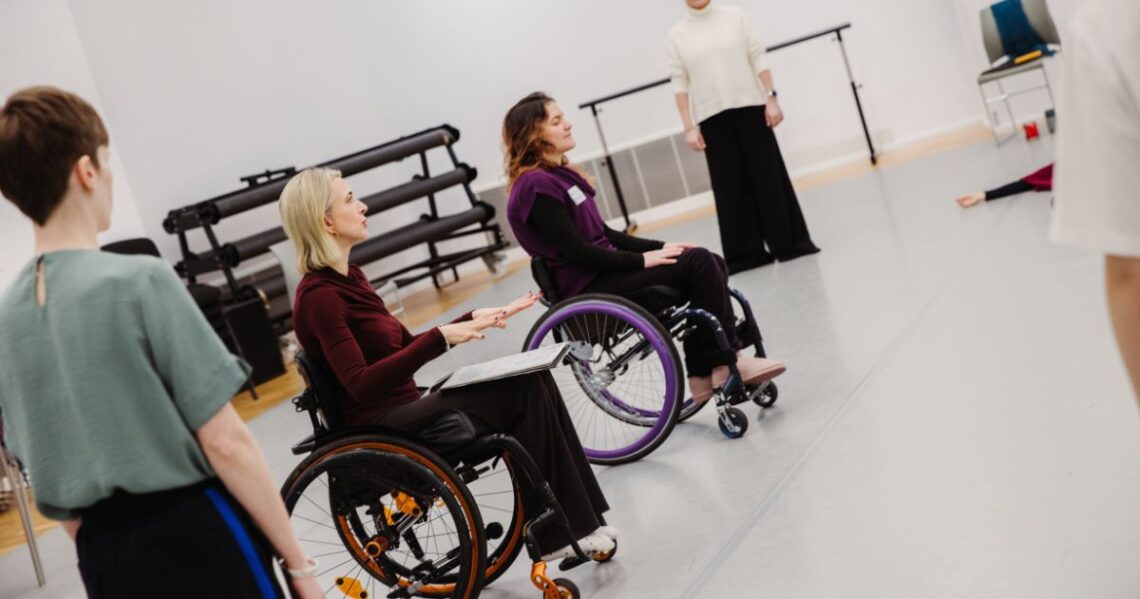 wheelchair and standing dancers in studio