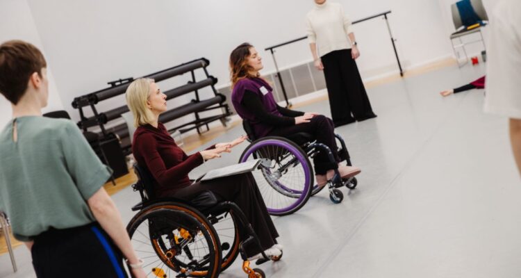 wheelchair and standing dancers in studio