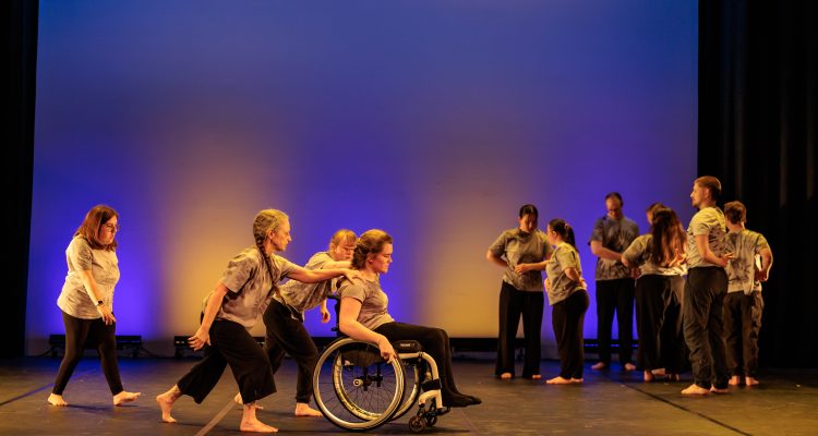 A group of disabled and non-disabled dancers onstage.